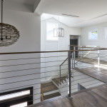 Second floor landing in custom home showing metal railing detail